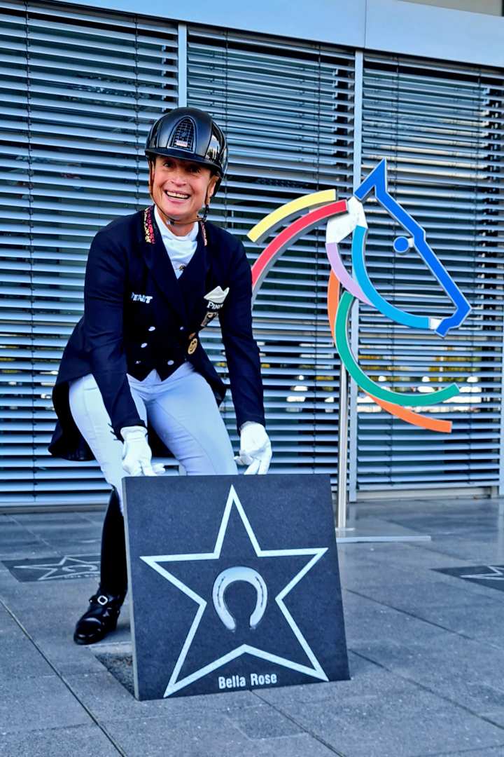Isabell Werth personally placing the plaque with the horseshoe of her “Bella Rose” into the ground at the Soers. Photo: CHIO Aachen/Nadine König
