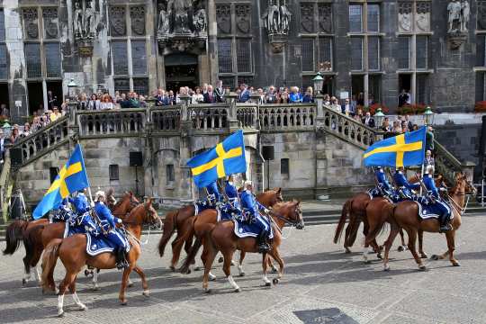 Magnificent parade of horses and carriages on the market place in the city centre of Aachen. 